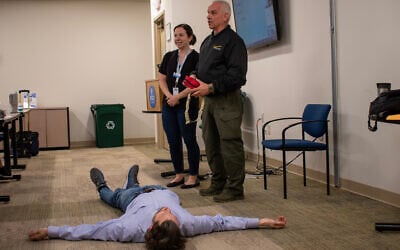 Maj. Oliver Fladrich from the Dunwoody Police Department near Atlanta teaches employees at Jewish Family & Career Services (JF&CS) how to defend themselves in the event of a violent attack, December 2023. (Katja Ridderbusch)