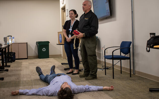 Maj. Oliver Fladrich from the Dunwoody Police Department near Atlanta teaches employees at Jewish Family & Career Services (JF&CS) how to defend themselves in the event of a violent attack, December 2023. (Katja Ridderbusch)