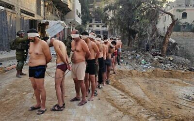Palestinian men surrender to troops in northern Gaza's Jabaliya, on December 10, 2023. (Social media; used in accordance with Clause 27a of the Copyright Law)