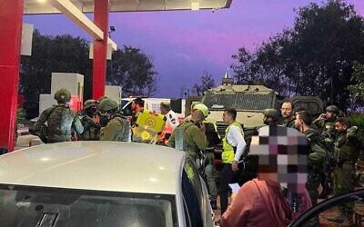 First responders at the scene of a stabbing attack at the Rantis checkpoint in the West Bank on December 17, 2023. (Magen David Adom)
