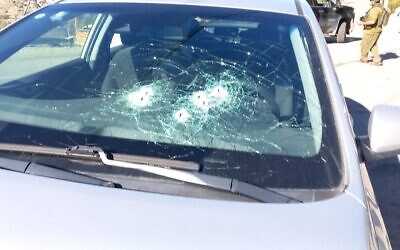 An Israeli vehicle in which a woman was wounded after coming under fire in a West Bank terror attack on December 18, 2023 (Binyamin council)