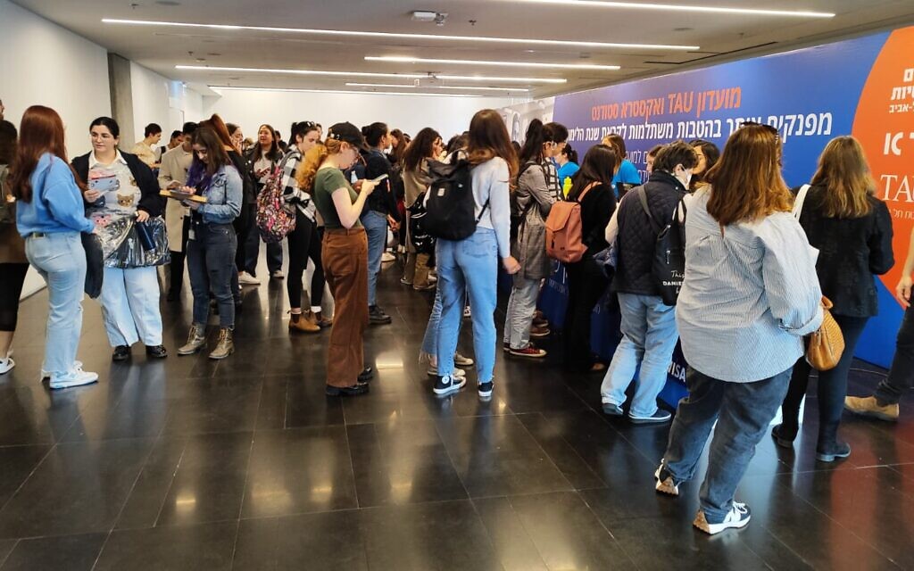 Students wait in line to get their student ID cards, at Tel Aviv University, on December 31, 2023. (Gavriel Fiske/TOI)