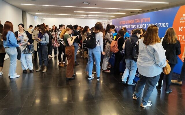 Students wait in line to get their student ID cards, at Tel Aviv University, on December 31, 2023. (Gavriel Fiske/TOI)
