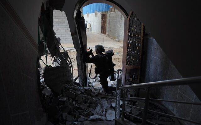 IDF soldiers seen operating in the Gaza Strip in this handout photo published on December 12, 2023. (IDF)