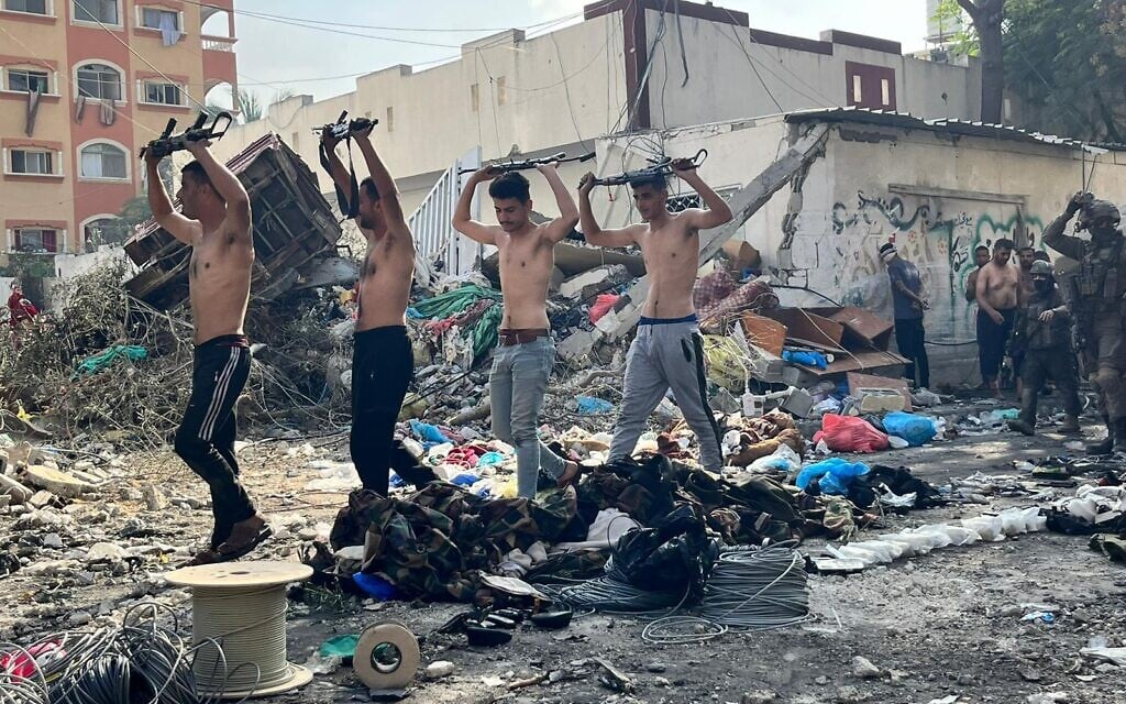 Hamas gunmen surrender to IDF troops at northern Gaza's Kamal Adwan Hospital, in a handout image published December 14, 2023. (Israel Defense Forces)