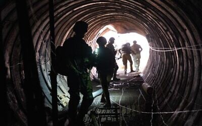 Soldiers stand in a large Hamas tunnel found near the Erez border crossing in the northern Gaza Strip, in a handout image published December 17, 2023. (Israel Defense Forces)