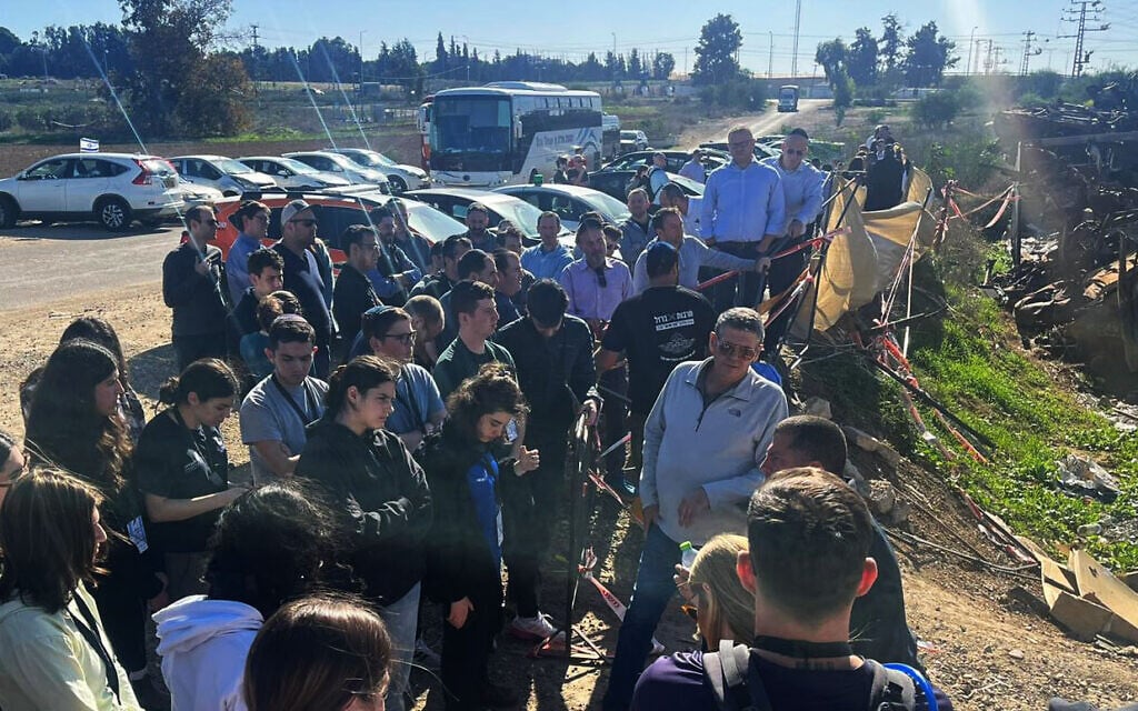 Students from North American universities survey the so-called car cemetery, full of vehicles of victims of the Nova music festival, in southern Israel on December 26, 2023. (Hasbara Fellowships)