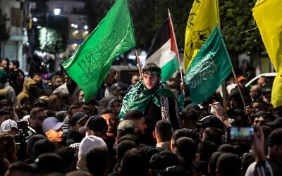File: A Palestinian security prisoner gestures among supporters and relatives after being released from Israeli jail in exchange for Israeli hostages released by Hamas from the Gaza Strip, in Ramallah in the West Bank on November 26, 2023. (Photo by Fadel SENNA / AFP)