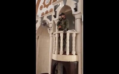 An IDF soldier sings from the imam's platform of a mosque in the West Bank city of Jenin, December 14, 2023. (X video screenshot: used in accordance with Clause 27a of the Copyright Law)