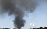 Heavy smoke rises from a large tank belonging to the Europe Asia Pipeline Company, after being hit by a rocket on May 12, 2021, near Ashkelon. (Gili Yaari/Flash90)