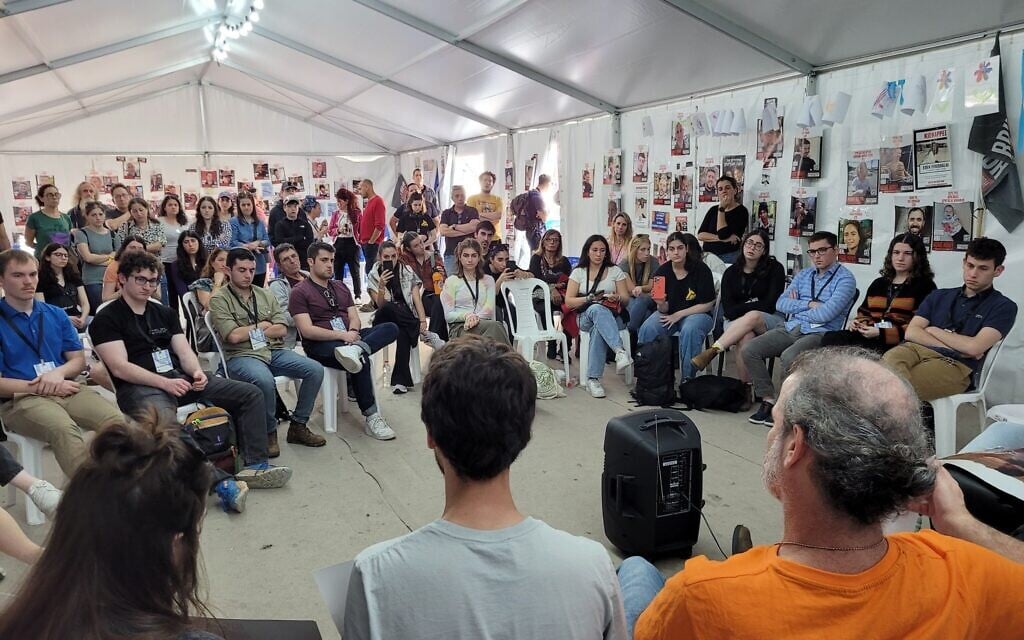 Students from North American universities listen to relatives of hostages in Gaza at Hostages Square in Tel Aviv on December 27, 2023. (Canaan Lidor/Times of Israel)