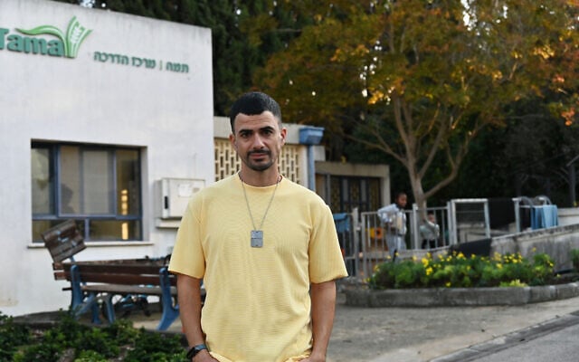 Nadav Tzabari of Kibbutz Nahal Oz walks past the Tama training center at Kibbutz Mishmar Ha'emek on December 6, 2023. (Canaan Lidor/Times of Israel)