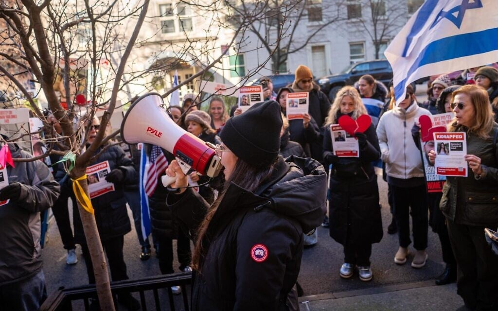 Protest leader Shany Granot-Lubaton leads a crowd outside the home of UN Secretary-General Antonio Guterres, January 5, 2024. (Luke Tress/JTA) Protest leader Shany Granot-Lubaton leads a crowd outside the home of UN Secretary-General Antonio Guterres, January 5, 2024. (Luke Tress/JTA)