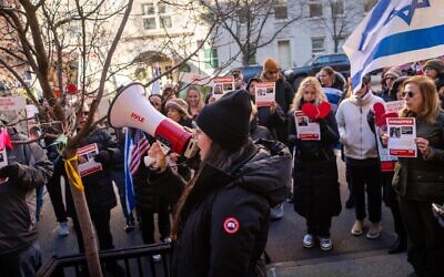 Protest leader Shany Granot-Lubaton leads a crowd outside the home of UN Secretary-General Antonio Guterres, January 5, 2024. (Luke Tress/JTA)