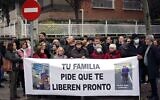 Protesters hold a banner reading 'Your family asks to be released soon' during a rally asking for the freedom of Santiago Sanchez Cogedor, near the Iranian embassy in Madrid, on December 18, 2022. (THOMAS COEX / AFP)
