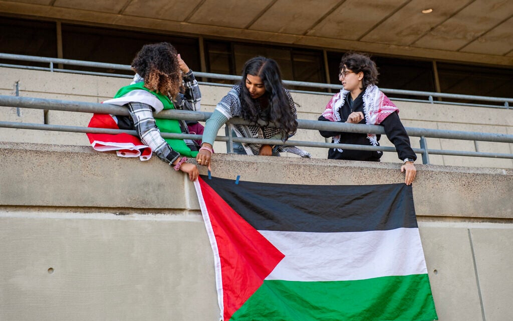 Students hang a Palestinian flag on the student center wall at a pro-Palestinian, anti-Israel rally at the Massachusetts Institute of Technology in Cambridge, Massachusetts, October 19, 2023. (Photo by Joseph Prezioso / AFP)