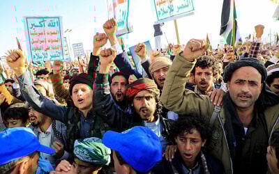 Yemenis chant slogans during a march in solidarity with the people of Gaza in the Houthi-controlled capital Sanaa on December 22, 2023. The official Houthi slogan is: The group's slogan officially goes: 'God Is the Greatest, Death to America, Death to Israel, A Curse Upon the Jews, Victory to Islam.' (Mohammed Huwais/AFP)