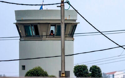An Israeli soldier mans a watchtower near the entrance to the Palestinian town of Azzun in the West Bank, on January 2, 2024. (Jaafar Ashtiyeh/AFP)