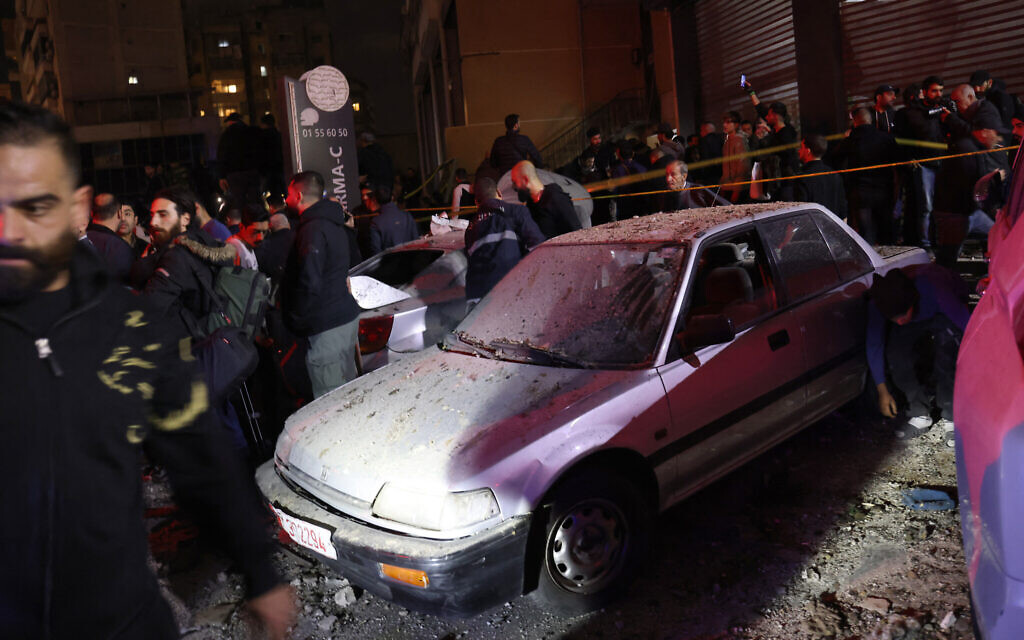 People gather at the site of a blast, reported by Lebanese media to be an Israeli strike targeting a Hamas office, in the southern suburb of Beirut on January 2, 2024, in which Hamas deputy leader Salah al-Arouri was killed. (Anwar Amro/AFP)