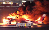 This photo provided by Jiji Press shows a Japan Airlines plane on fire on a runway of Tokyo's Haneda Airport on January 2, 2024. (Photo by JIJI PRESS/AFP)