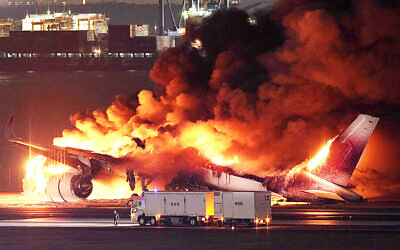 This photo provided by Jiji Press shows a Japan Airlines plane on fire on a runway of Tokyo's Haneda Airport on January 2, 2024. (Photo by JIJI PRESS/AFP)
