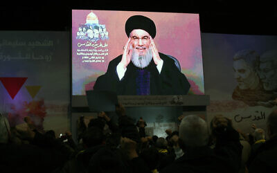 People watch a televised speech by Lebanon's Hezbollah terror chief Hassan Nasrallah in a Beirut southern suburb on January 3, 2024. (ANWAR AMRO / AFP)