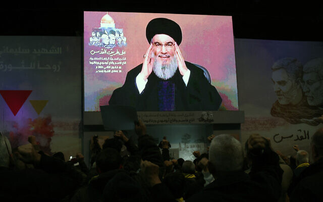 People watch a televised speech by Lebanon's Hezbollah terror chief Hassan Nasrallah in a Beirut southern suburb on January 3, 2024. (ANWAR AMRO / AFP)