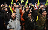Supporters shout slogans during the commemorations of the anniversary of the killing of slain top Iranian commander Qasem Soleimani, marked by a televised speech by Lebanon's Hezbollah chief Hasan Nasrallah in a Beirut southern suburb on January 3, 2024.(ANWAR AMRO / AFP)
