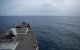 The Arleigh Burke-class guided-missile destroyer USS Laboon approaches the oiler USNS Kanawha (background) for replenishment-at-sea operation in the Red Sea on December 25, 2023, in this handout photo. (Elexia Morelos / US Department of Defense / AFP)