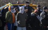 NYPD officers arrest anti-Israel, pro-Palestinian protesters as they gathered and blocked the Manhattan entrance of the Brooklyn Bridge on January 8, 2024, in New York City. (ANGELA WEISS/AFP)