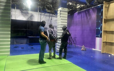 Police officers arrest one of the unidentified gunmen who burst into a studio of the state-owned TC television while live, in Guayaquil, Ecuador, on January 9, 2024, a day after Ecuadorean President Daniel Noboa declared a state of emergency following the escape from prison of a dangerous narco boss. (AFP)