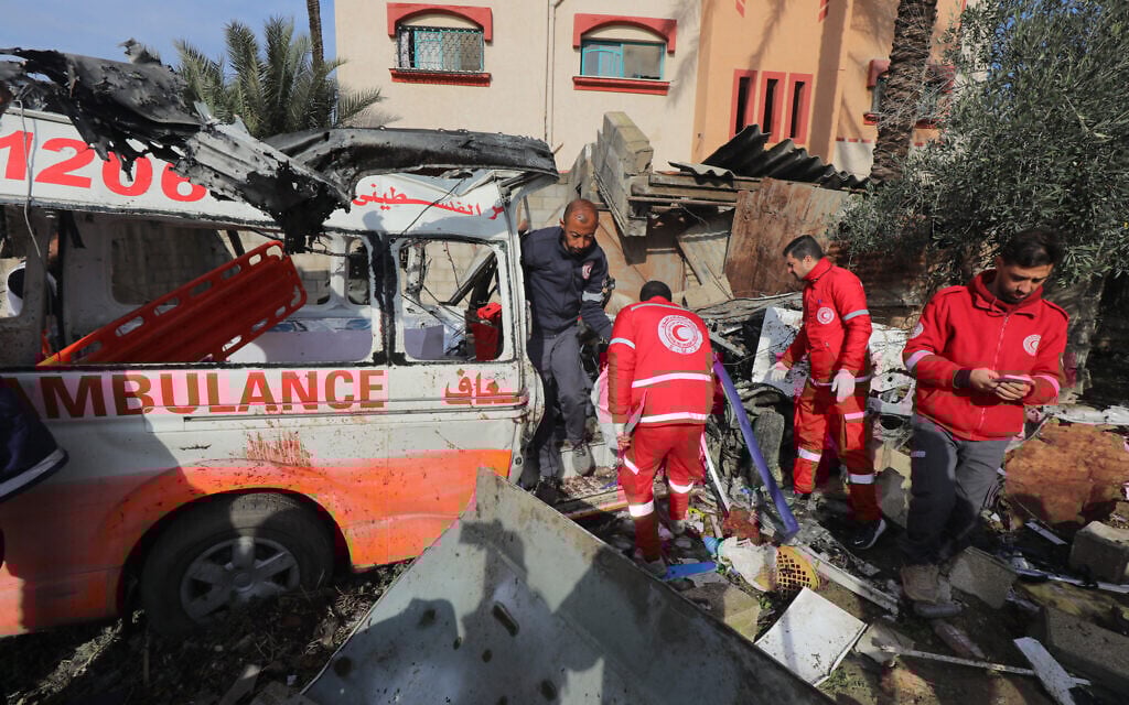 Palestinian Red Crescent personnel check a destroyed ambulance in Deir el-Balah in the central Gaza Strip, on January 11, 2024. (AFP)