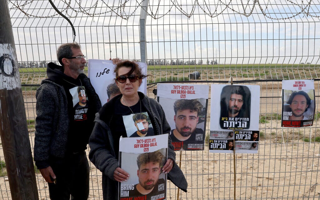 Relatives of Israeli hostages held by  Hamas gather along the Gaza border, equipped with powerful loudspeakers hanging from cranes, in an effort to get messages of hope across to them as their time in captivity nears to 100 days, on January 11, 2024. (Jack Guez / AFP)