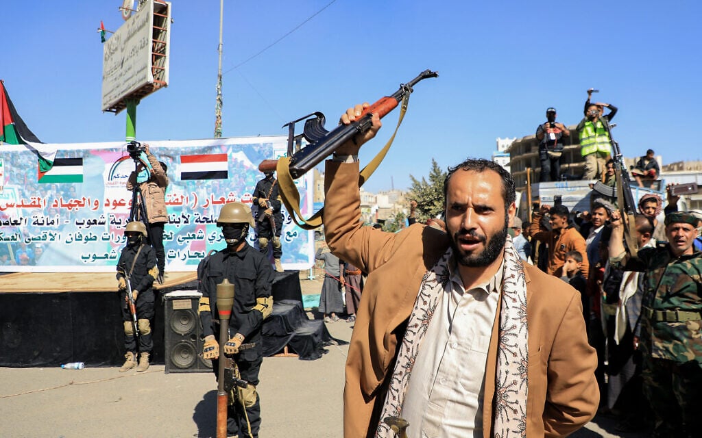 Demonstrators shout slogans and brandish their weapons during a march in solidarity with the Palestinian people, in the Huthi-controlled capital Sanaa on January 11, 2024. (Mohammed Huwais/AFP)