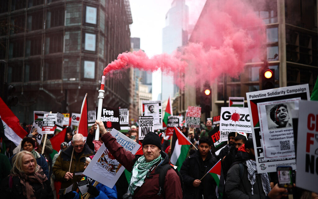 Activists and supporters wave flags and carry placards during a National March for Palestine in central London on January 13, 2024. (Henry Nicholls/AFP)