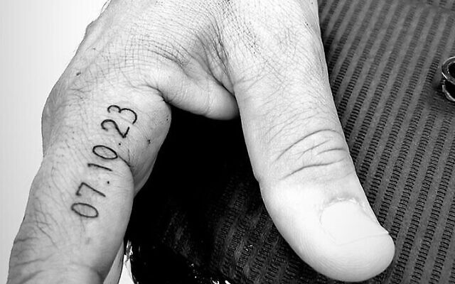 A '7.10' tattoo on the hand of an evacuee from Kibbutz Erez. (Lior Yosefi)