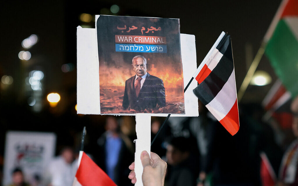 A Kuwaiti man holds a placard bearing the portrait of Israeli Prime Minister Benjamin Netanyahu during a rally in solidarity with the people of Gaza at Iradah Square in Kuwait City on January 14, 2024. (Photo by YASSER AL-ZAYYAT / AFP) A Kuwaiti man holds a placard bearing the portrait of Israeli Prime Minister Benjamin Netanyahu during a rally in solidarity with the people of Gaza at Iradah Square in Kuwait City on January 14, 2024. (Photo by YASSER AL-ZAYYAT / AFP)