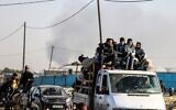 Palestinian families fleeing Khan Younis on the coastal road leading to Rafah, amid ongoing battles between Israel and the Palestinian terrorist group Hamas, January 22, 2024. (AFP)