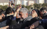 People mourn over the coffins of three Iranian Revolutionary Guard Corps (IRGC) members killed in Damascus in a strike blamed on Israel on January 20, during their funeral in the Iranian capital Tehran on January 22, 2024. (Atta Kenare/ AFP)