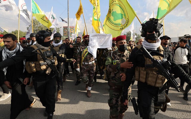Members of the Hashed al-Shaabi carry the coffin of a comrade, who died in American airstrikes targeting Iran-backed militia groups the day before, during his funeral at the Hashed al-Shaabi headquarters in Baghdad on January 25, 2024. (Ahmad Al-Rubaye/AFP)
