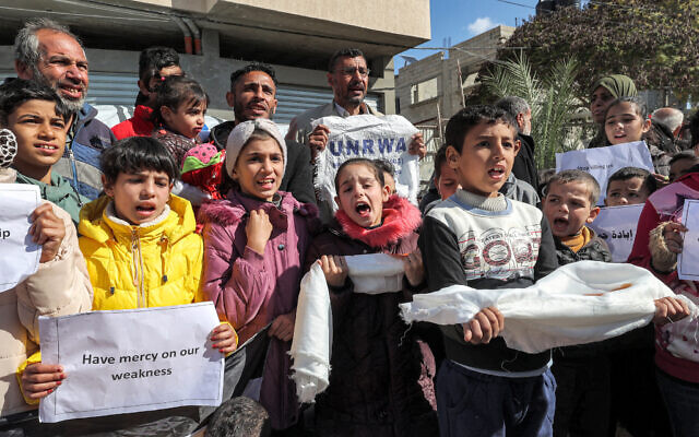 Palestinian men and children gather for a demonstration in Rafah in the southern Gaza Strip on January 30, 2024, calling for continued international support to the United Nations Relief and Works Agency. (AFP)