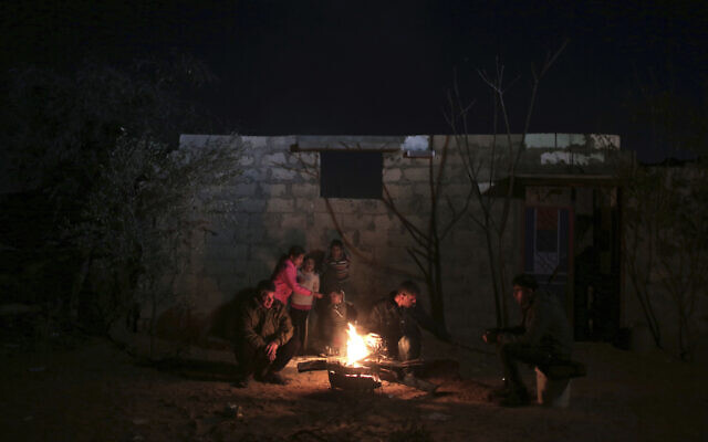 Illustrative: In this Sunday, Jan. 15, 2017 photo, a family warm themselves up with a fire outside their makeshift house during the power cut in a poor neighborhood in town of Khan Younis in the southern Gaza Strip. (AP Photo/ Khalil Hamra) Illustrative: In this Sunday, Jan. 15, 2017 photo, a family warm themselves up with a fire outside their makeshift house during the power cut in a poor neighborhood in town of Khan Younis in the southern Gaza Strip. (AP Photo/ Khalil Hamra)