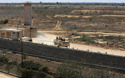 File: An Egyptian armored vehicle patrols on the Egyptian side of the border as bulldozers work on the Gaza side to create a buffer zone, in Rafah, Wednesday, June 28, 2017 (AP Photo/Adel Hana)