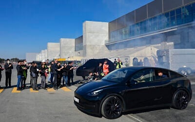 File - A Model Y electric vehicle rolls out of the factory at the opening of the Tesla factory in Berlin Brandenburg in Gruenheide, Germany, March 22, 2022.  (Patrick Pleul/Pool via AP)