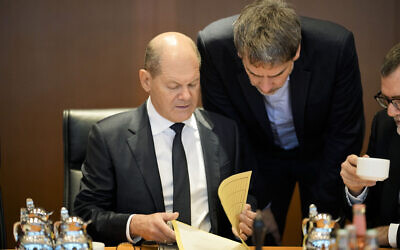 German Chancellor Olaf Scholz, left, talks to government's spokesman Steffen Hebestreit during weekly cabinet meeting of the German government at the chancellery in Berlin, Germany, Jan. 25, 2023. (AP Photo/Markus Schreiber)
