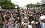 Houthi supporters chant slogans at a rally marking eight years for a Saudi-led coalition, Friday, March 26, 2023, in Sanaa, Yemen. (AP/Hani Mohammed)