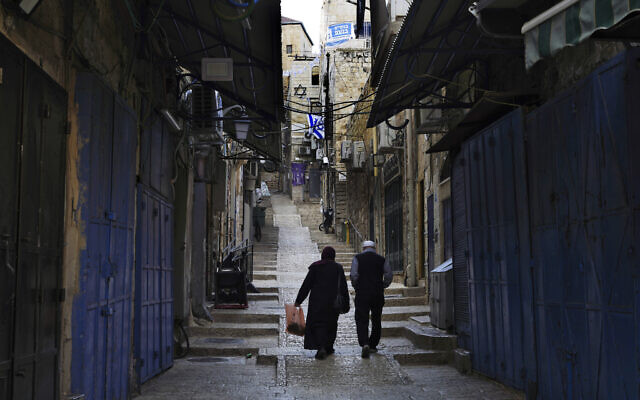 Palestinians walk past closed shops in the Old City of Jerusalem, Oct. 16, 2023. (AP Photo/Jon Gambrell) Palestinians walk past closed shops in the Old City of Jerusalem, Oct. 16, 2023. (AP Photo/Jon Gambrell)