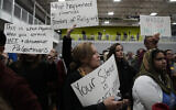 Mourners hold signs during a vigil at Prairie Activity and Recreation center in Plainfield, Illinois, for 6-year-old Wadea Al Fayoume who was fatally stabbed in a suspected anti-Palestinian hate crime, October 17, 2023. (AP Photo/Nam Y. Huh)