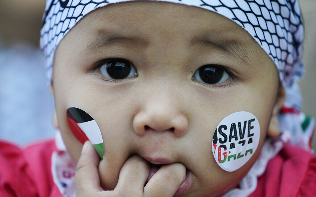 An infant wears stickers of Palestinian flags at an anti-Israel, pro-Palestinian rally in Kuala Lumpur, Malaysia, October 24, 2023. (AP Photo/Vincent Thian)