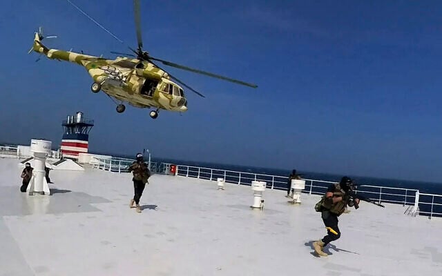 This photo released by the Houthi Media Center shows Houthi forces boarding the cargo ship Galaxy Leader, November 19, 2023. (Houthi Media Center via AP, File)